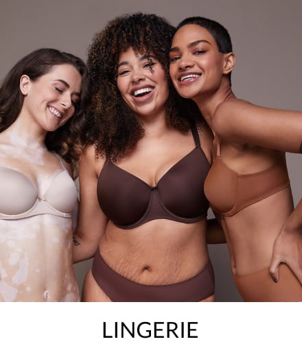 Three women wearing shades of nude bra and knicker sets.