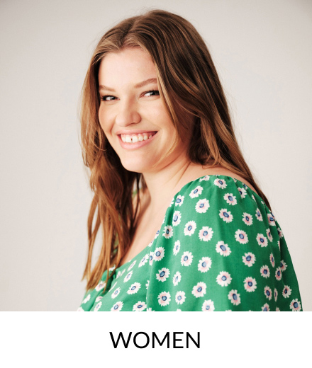 A smiling woman wearing a green floral top.