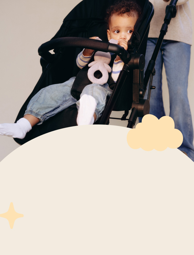Baby sitting in pushchair.