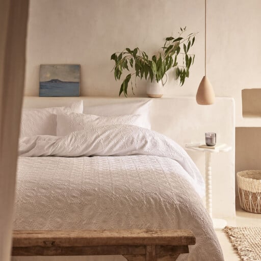 Room features double bed with neutral homeware.