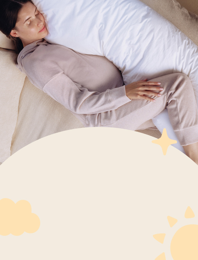 Woman sleeping with maternity pillow.